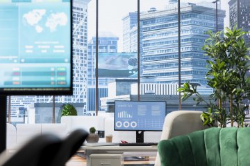 Computer screen showcases business data and statistics in professional boardroom